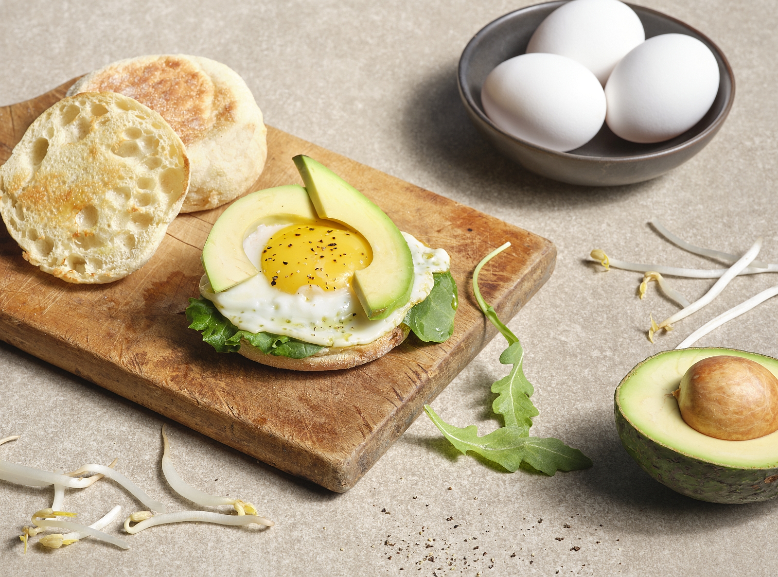 egg with avocado slices and english muffin